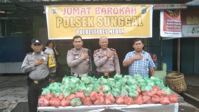 Jumat Barokah, Kapolsek Sunggal Bagikan Nasi Bungkus kepada Warga